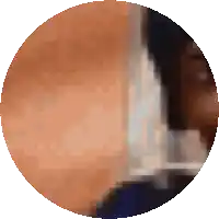 a close up of a person 's face in a circle with a blurry background