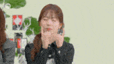 a girl with her eyes closed and her hands on her face .