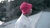 a man wearing a pink hat and a white shirt