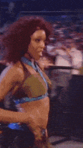 a woman with red hair is dancing in a crowd