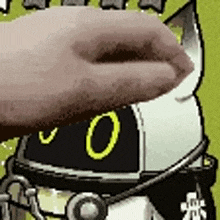 a close up of a person 's hand holding a cat 's head .