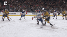 a hockey game is being played in front of a banner that says taverns headquarters
