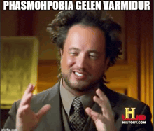a man in a suit and tie is making a funny face with the caption phasmophobia gelen varmudur
