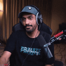 a man wearing headphones and a black shirt that says billabong