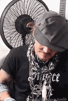 a man wearing a black shirt that says darkness