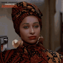 a woman is wearing a turban and earrings and says eddie murphy coming to america on the bottom