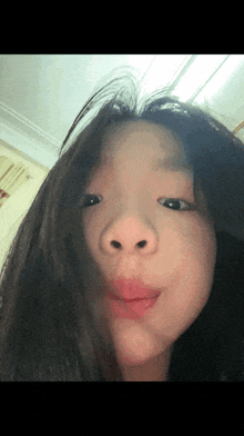 a close up of a girl making a face
