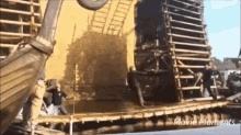 a group of people standing on top of a wooden structure with the words movie moments on the bottom