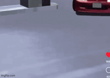 a red car is driving down a street with a heart on the bottom right of the screen .
