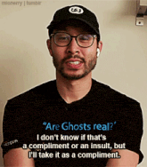 a man wearing glasses and a hat says " are ghosts real ? "