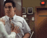 a man in a white shirt and tie is talking to a woman in front of a door that says ' closed ' on it
