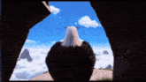 a bald eagle looks out over a cloudy sky from a cave
