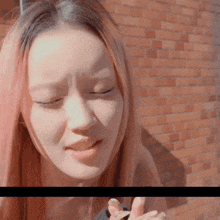 a close up of a woman 's face with her eyes closed