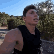 a man wearing a weighted vest looks up at something