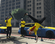 a man in a yellow shirt is doing a handstand in front of a car that says canton towing