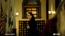 a woman walking in a hallway with the hashtag #chicagopd on it