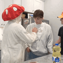 a bottle of vegetable oil sits on a counter next to a man