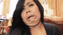 a woman making a funny face with her mouth wide open