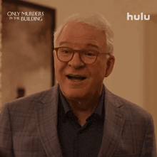 a man in a suit and glasses is smiling in a hulu ad