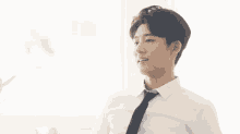 a man in a white shirt and black tie is looking down at something