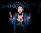 a man with blue hair wearing headphones and a sequined jacket