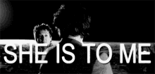 a black and white photo of a man dancing with the words `` she is to me '' .