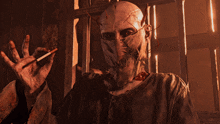 a man with a mask on his face holds a cigarette