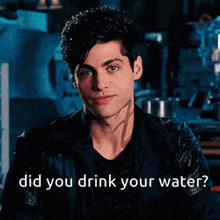 a man with a tattoo on his face is asking if he drinks water