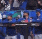 a blurry picture of a baseball team standing in the dugout