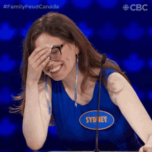 a woman with a name tag that says sydney is laughing