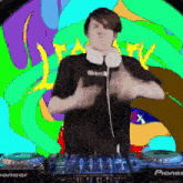 a man stands behind a pioneer dj mixer