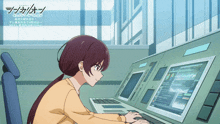 a girl is sitting at a desk with a computer and a sign above her that says ' tokyo ghoul '