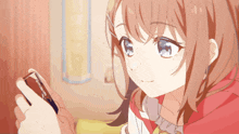 a girl with red hair and blue eyes is looking at a cell phone