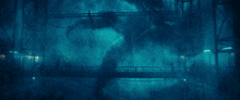 a bridge in a dark room with a blue light coming out of it