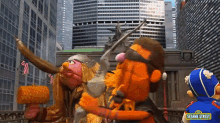 sesame street characters are standing in front of a skyscraper