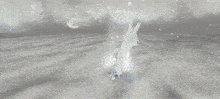 a woman in a white dress is kneeling down in a snowy field .