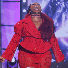 a woman in a red jacket and pants is screaming