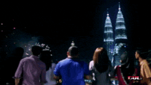 a group of people watching a fireworks display with the word hulu visible in the lower right corner