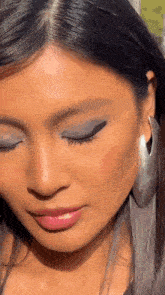 a close up of a woman wearing hoop earrings