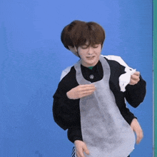 a man wearing an apron is being held by another man while holding a napkin .