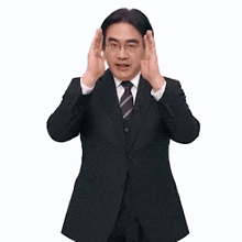 a man in a suit and tie is standing in front of a sign that says full focus