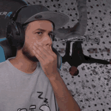 a man wearing headphones and a hat with the letter n on it