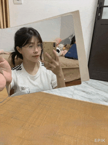 a girl is taking a picture of herself in a mirror with the word epic on the bottom