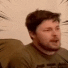 a man with a beard is making a funny face .