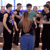a group of young people are dancing together in a gym