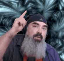 a man with a beard wearing headphones and a adidas hat