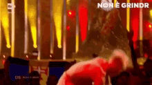a man is dancing on a stage in front of a crowd with the words non e grindr on the bottom
