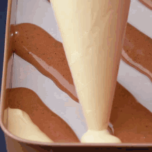 a person is pouring a yellow liquid into a pan