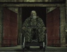 a man with a beard is sitting in a chair with a camouflage outfit on