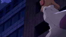 a woman wearing headphones stands in front of a tall building